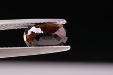 Faceted Painite and cutting- grade Crystal